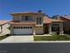 Two-story home featuring a two-car garage, desert landscaping and a red tile roof at 5024 Saint Annes Dr, Las Vegas, NV 89149