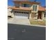 Charming stucco home with a two-car garage, red tile roof, and well-manicured lawn at 5024 Saint Annes Dr, Las Vegas, NV 89149