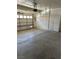 Spacious garage with concrete flooring and a roll-up garage door with an automatic opener at 5024 Saint Annes Dr, Las Vegas, NV 89149