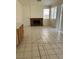Living Room with a fireplace and natural light from windows with bright neutral tile floors at 5024 Saint Annes Dr, Las Vegas, NV 89149