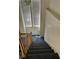 Staircase with carpeted steps, and wooden railing, leading to the upper level at 5024 Saint Annes Dr, Las Vegas, NV 89149