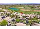Expansive aerial view of the house with golf course and community pool in a desert landscape near Las Vegas at 512 Pima Canyon Ct, Las Vegas, NV 89144