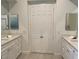 Bright bathroom featuring dual sinks with white countertops at 512 Pima Canyon Ct, Las Vegas, NV 89144