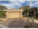 Tan single-story home with tan colored garage and desert landscaping out front at 512 Pima Canyon Ct, Las Vegas, NV 89144
