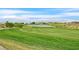 Scenic view of the golf course and pond on a sunny day at 512 Pima Canyon Ct, Las Vegas, NV 89144
