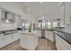 Bright kitchen features white cabinets, stainless steel appliances and a marble island at 512 Pima Canyon Ct, Las Vegas, NV 89144