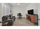 Cozy living room offers comfortable seating, desk and TV at 512 Pima Canyon Ct, Las Vegas, NV 89144
