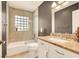 Modern bathroom featuring a bathtub, a walk-in shower, and a stylish vanity with ample counter space and elegant fixtures at 5142 Southern Hills Ln, Las Vegas, NV 89113