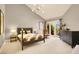 Spacious bedroom with high ceilings, modern lighting, and access to the backyard at 5142 Southern Hills Ln, Las Vegas, NV 89113