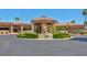 A main entrance to the community clubhouse with mature landscaping and palm trees at 5142 Southern Hills Ln, Las Vegas, NV 89113
