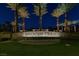Night view of the Spanish Trail community entrance with palm trees and manicured landscaping at 5142 Southern Hills Ln, Las Vegas, NV 89113