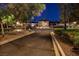 A main entrance to the community area with a roundabout and palm trees at 5142 Southern Hills Ln, Las Vegas, NV 89113