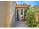 A home entry way with double doors with potted greenery around a patio chair at 5142 Southern Hills Ln, Las Vegas, NV 89113