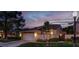 Charming single-story home with manicured lawn, attached garage, and beautiful evening sky at 5142 Southern Hills Ln, Las Vegas, NV 89113