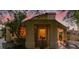 Charming covered patio at dusk with lounge chairs, plants, and a glimpse of the home's cozy interior at 5142 Southern Hills Ln, Las Vegas, NV 89113