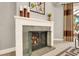 Close-up of a cozy fireplace with a white brick surround and modern glass doors at 5142 Southern Hills Ln, Las Vegas, NV 89113