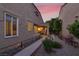 Inviting front yard with walkway, mature landscaping and charming exterior of the home, bathed in the warm light of sunset at 5142 Southern Hills Ln, Las Vegas, NV 89113