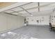 Spacious two-car garage with epoxy flooring, built-in storage cabinets, and ample room for parking and projects at 5142 Southern Hills Ln, Las Vegas, NV 89113