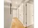 Hallway with wood floors and multiple doors at 5142 Southern Hills Ln, Las Vegas, NV 89113
