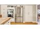 Kitchen featuring stainless steel refrigerator, granite countertops, and white cabinetry at 5142 Southern Hills Ln, Las Vegas, NV 89113