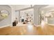 Bright living room with hardwood floors, fireplace, and open layout, seamlessly connecting to the kitchen and dining area at 5142 Southern Hills Ln, Las Vegas, NV 89113