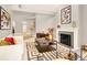 Spacious living room with modern decor, fireplace, and plush white sofa at 5142 Southern Hills Ln, Las Vegas, NV 89113
