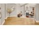 Open-concept living room featuring wood floors, a cozy fireplace, and stylish decor; inviting for relaxation and entertainment at 5142 Southern Hills Ln, Las Vegas, NV 89113