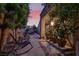 Serene outdoor space with rocking chairs and vibrant plants leading to a charming covered walkway and entry area at 5142 Southern Hills Ln, Las Vegas, NV 89113