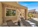 An outside patio area with two lounge chairs, a small table, and views to the garden at 5142 Southern Hills Ln, Las Vegas, NV 89113