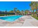 Resort-style pool with lounge chairs and mature palms under a bright blue sky creates an oasis for relaxation and recreation at 5142 Southern Hills Ln, Las Vegas, NV 89113