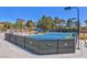 An outside tennis court facility with a net, lights and fence at 5142 Southern Hills Ln, Las Vegas, NV 89113