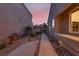 Charming walkway with desert landscaping, leading to a private backyard gate and showcasing the home's exterior at 5142 Southern Hills Ln, Las Vegas, NV 89113