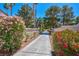 Inviting community walkway lined with colorful flowers and lush landscaping under a clear blue sky at 5142 Southern Hills Ln, Las Vegas, NV 89113