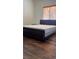 Bedroom featuring a dark wood sleigh bed frame and wood floors with natural light at 5250 S Rainbow Blvd # 1140, Las Vegas, NV 89118
