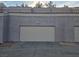 Attached garage door and exterior features a tiled roof in this multi-Gathering residence at 5250 S Rainbow Blvd # 1140, Las Vegas, NV 89118