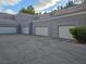 Multiple garage doors with an asphalt driveway on a sunny day at 5250 S Rainbow Blvd # 1140, Las Vegas, NV 89118