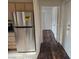 Hallway leading to kitchen with stainless steel refrigerator at 5250 S Rainbow Blvd # 1140, Las Vegas, NV 89118