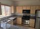 The kitchen features granite counters and stainless appliances for a sleek, modern appearance at 5250 S Rainbow Blvd # 1140, Las Vegas, NV 89118