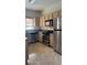 Well-lit kitchen equipped with stainless steel appliances, wood cabinets, and stone countertops at 5250 S Rainbow Blvd # 1140, Las Vegas, NV 89118