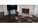 Modern living room featuring hardwood floors, a fireplace, and a glass-top table for decor at 5250 S Rainbow Blvd # 1140, Las Vegas, NV 89118