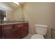 Bathroom with a toilet, granite countertop vanity, and modern mirror at 5383 Indian River Dr # 323, Las Vegas, NV 89103