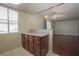 Bright breakfast bar features granite countertops and dark cabinets between the kitchen and living area at 5383 Indian River Dr # 323, Las Vegas, NV 89103