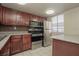Updated kitchen with sleek stainless steel appliances, dark wood cabinets and mosaic tile backsplash at 5383 Indian River Dr # 323, Las Vegas, NV 89103