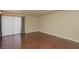 Spacious, bright living room with rich hardwood floors and sliding glass door with contemporary curtains at 5383 Indian River Dr # 323, Las Vegas, NV 89103