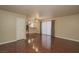 Open-concept living room with gleaming hardwood floors flowing into a kitchen area with sleek appliances at 5383 Indian River Dr # 323, Las Vegas, NV 89103