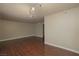 Expansive open-concept living room with hardwood floors, modern lighting and neutral wall colors at 5383 Indian River Dr # 323, Las Vegas, NV 89103