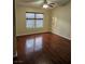 Spacious bedroom featuring wood-look laminate flooring, a ceiling fan, and a bright window at 555 E Silverado Ranch Blvd # 2052, Las Vegas, NV 89183