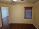 Neutral bedroom with wood-look laminate flooring, ceiling fan, and horizontal blinds on the window at 555 E Silverado Ranch Blvd # 2052, Las Vegas, NV 89183