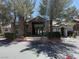 Exterior view of the 'First Saturday Coffee & Chat' clubhouse, featuring stone accents and well-manicured landscaping at 555 E Silverado Ranch Blvd # 2052, Las Vegas, NV 89183