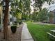 Community green space featuring a walkway, lush landscaping, and picnic table under mature trees at 555 E Silverado Ranch Blvd # 2052, Las Vegas, NV 89183
